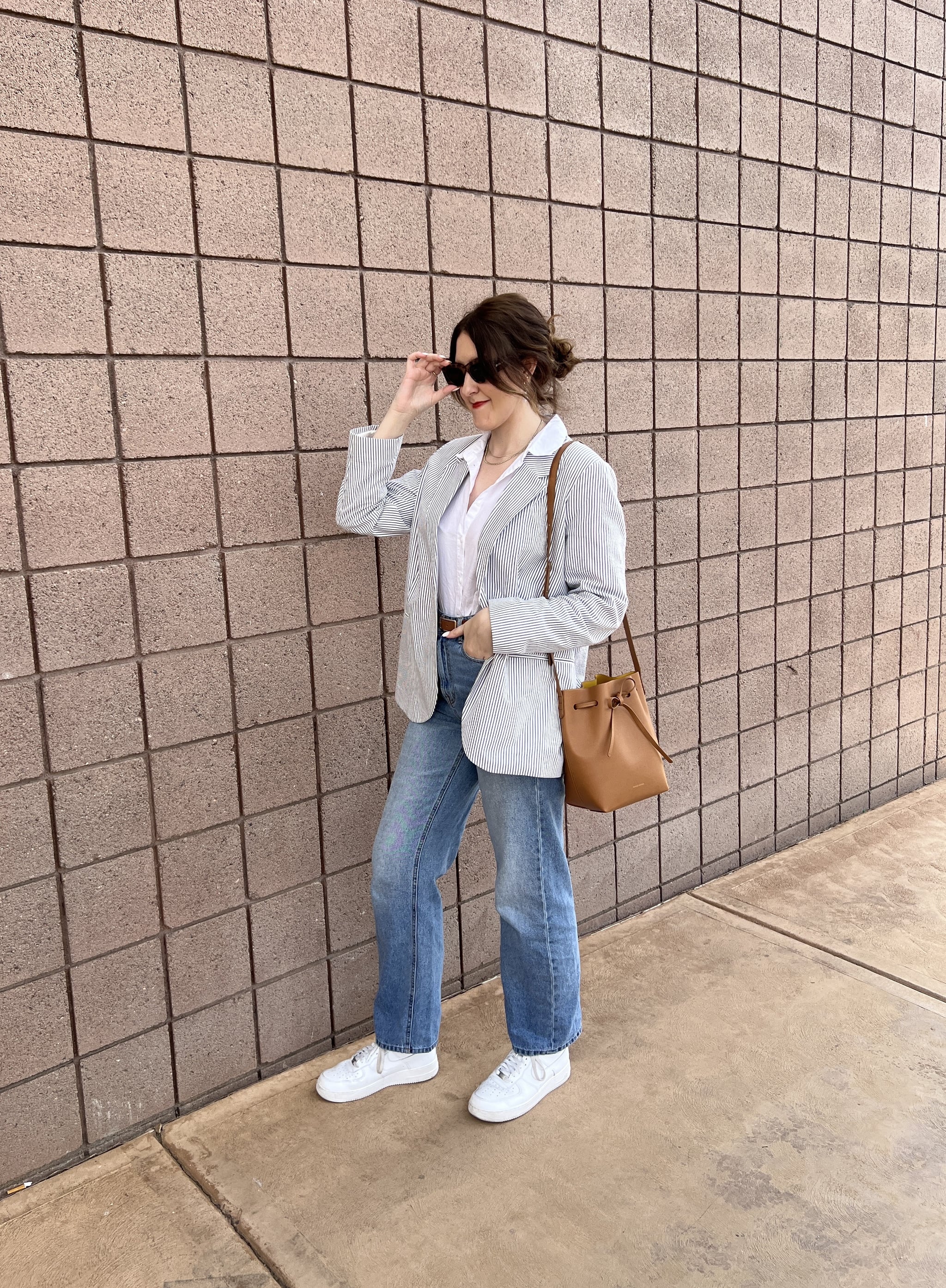 woman carrying Mansur Gavriel Apple Leather Bucket Bag