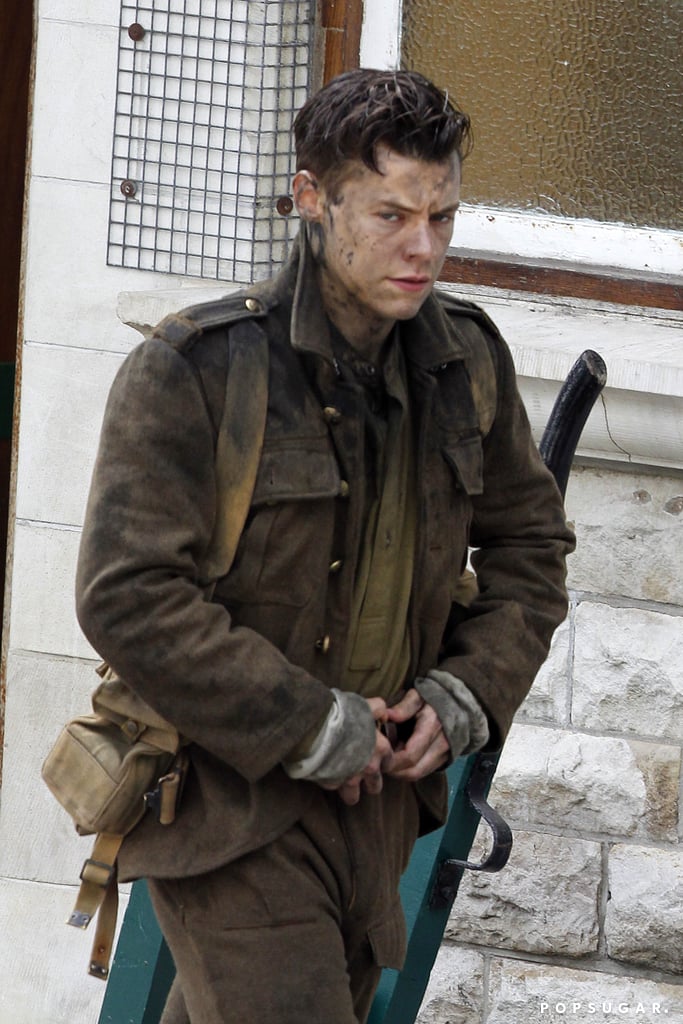 Now that Harry Styles has officially severed ties with One Direction, the curly haired singer is putting his best foot forward in the acting world. Styles was seen filming scenes for Dunkirk, a war movie about a fierce World War II battle, in Swanage, England, on Monday, where he was laughing and guzzling a bottle of beer from a train as a crowd looked on. Later, he was photographed looking pretty battle-worn, dressed in an army uniform and covered in dirt and mud. Definitely a different look than what we're used to seeing on stage, huh?
