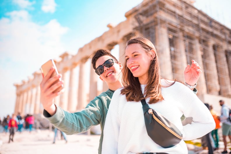 Tourist couple taking a selfie  in Acropolis - Athens.