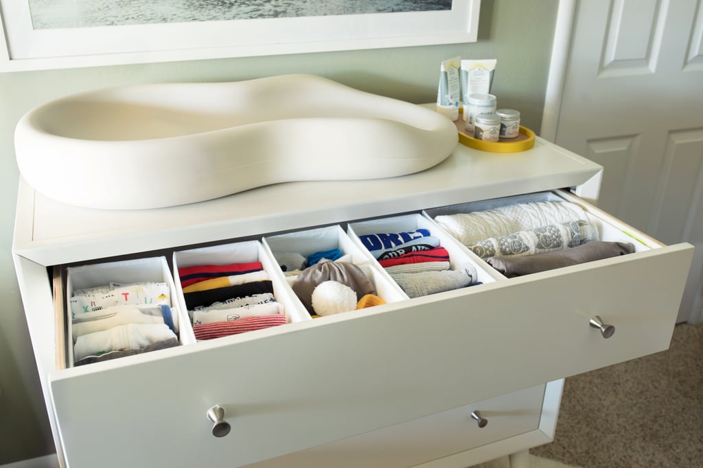 We placed a dresser ($589) on the wall next to the closet door and set a Keekaroo Peanut Changer ($126-$130) on top of the dresser. Instead of giving up the top drawer of the dresser for storing diapers, wipes, and toiletries, I knew I wanted to use it for the boys' clothes. I filled it with these Ikea Skubb Drawer Organizers ($6 for a set of six) and hung an over-the-door storage system on the closet door to hold diaper-changing necessities.