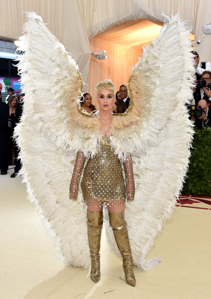 Heaven must be missing an angel, because Katy Perry just graced the Met Gala red carpet. The American Idol judge had us saying "amen" in a custom Versace chainmail-ensconced minidress featuring the evening's on-trend gold hue. Embracing the "Heavenly Bodies" theme, the singer completed her outfit with gold cross earrings and complementary thigh-high boots. 
Oh, wait, are we missing something? No, of course we didn't miss the standout accessory of her look (and possibly the night!): her oversize white feathered wings. Paired with kneeled praying pose on the steps of the Metropolitan Museum in New York City, all that was missing from this ensemble was a halo.

    Related:

            
            
                                    
                            

            Every Look at the 2018 Met Gala Was Bold Enough to Leave an Impression