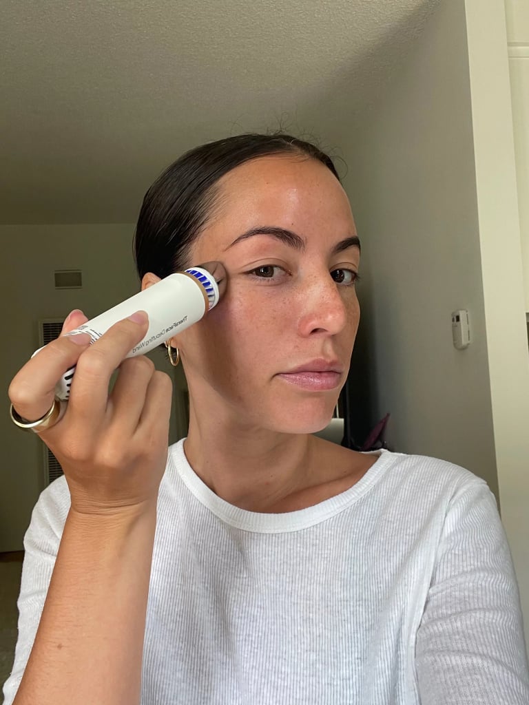 Therabody TheraFace Depuffing Wand ($170)
Let's face it, after spending a full day in the sun or having one too many piña coladas, we all wake up a little puffy. Luckily, this device takes the guesswork out of activating your lymphatic drainage system. The tip can alternate between hot and cold settings to help depuff, maximize product absorption, and elevate your DIY facial massage. According to our Therabody TheraFace Depuffing Wand review, it's even the perfect size for travel. 
Editor Quote: "This product gives me the cooling sensation I love, except I don't have to worry about water dripping down my face and neck, taking it in and out of the freezer, or waiting for it to get cold enough for me to use. At the press of a button I can oscillate between cold and hot treatments, and I can bring it with me anywhere I go. It's small enough to fit in my purse, and it even has a travel cap that fits over the top so I can make sure the applicator stays clean." — Renee Rodriguez, senior staff writer and social producer