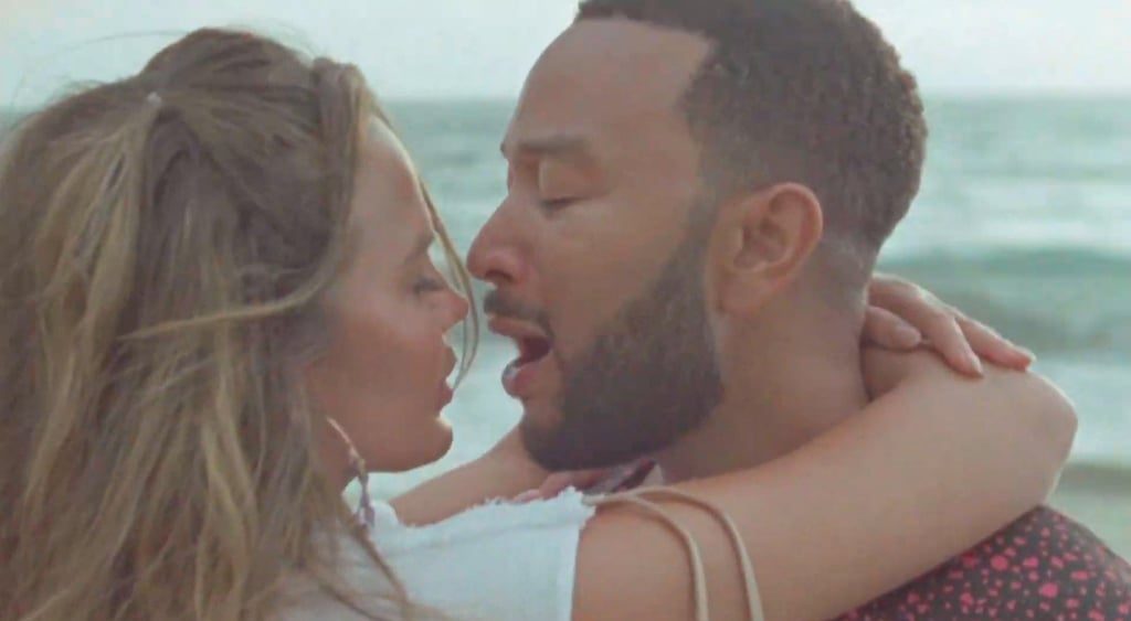 Chrissy Teigen Reveals Pregnancy in a White Dress in "Wild"