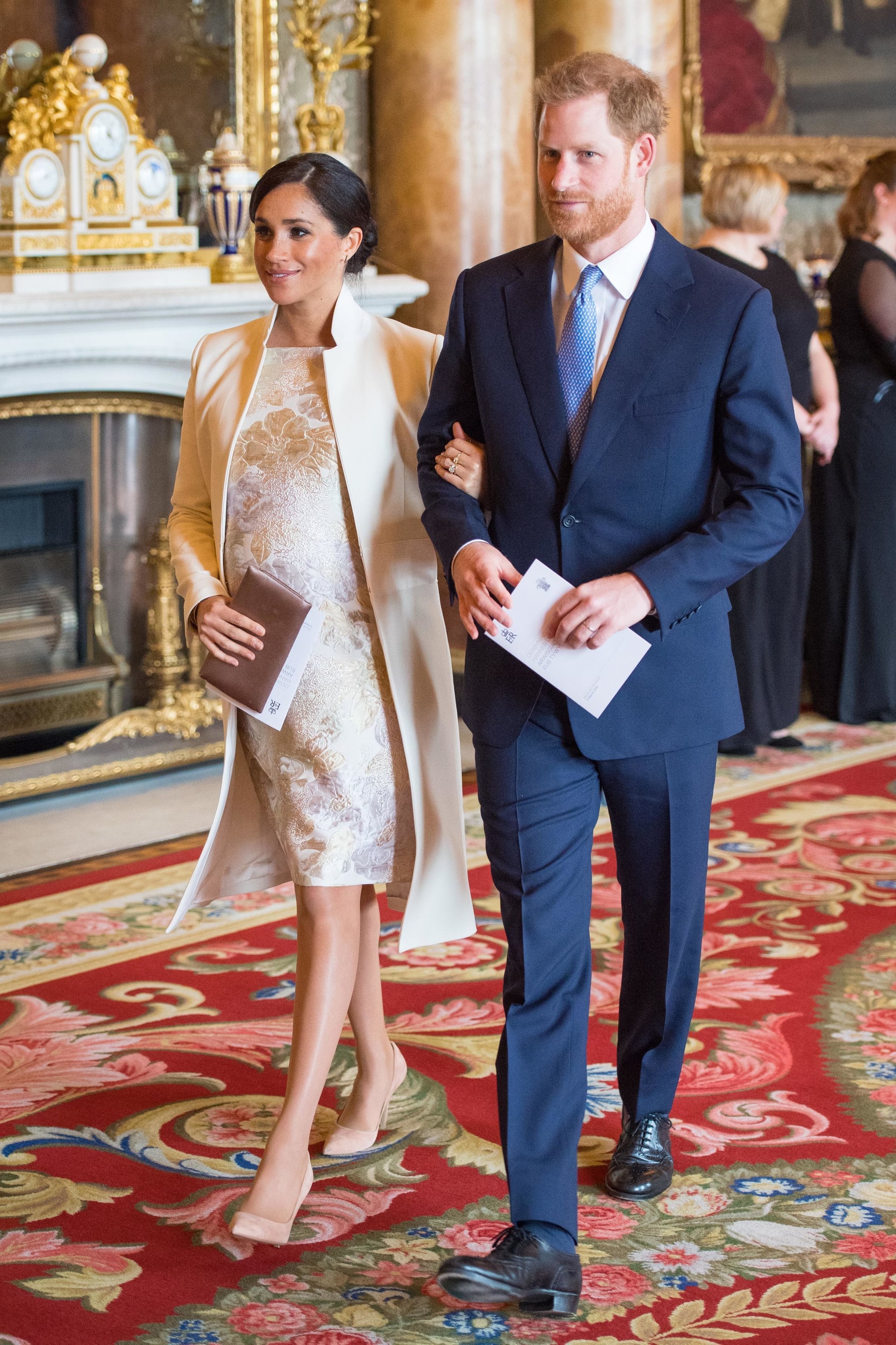 Britain's Prince Harry, Duke of Sussex, (R) and Britain's Meghan, Duchess of Sussex (L) attend a reception to mark the 50th Anniversary of the investiture of The Prince of Wales at Buckingham Palace in London on March 5, 2019. - The Queen hosted a reception to mark the Fiftieth Anniversary of the investiture of Britain's Prince Charles, her son, as the Prince of Wales. Prince Charles was created The Prince of Wales aged 9 on July 26th 1958 and was formally invested with the title by Her Majesty The Queen on July 1st 1969 at Caernarfon Castle. (Photo by Dominic Lipinski / POOL / AFP)        (Photo credit should read DOMINIC LIPINSKI/AFP/Getty Images)