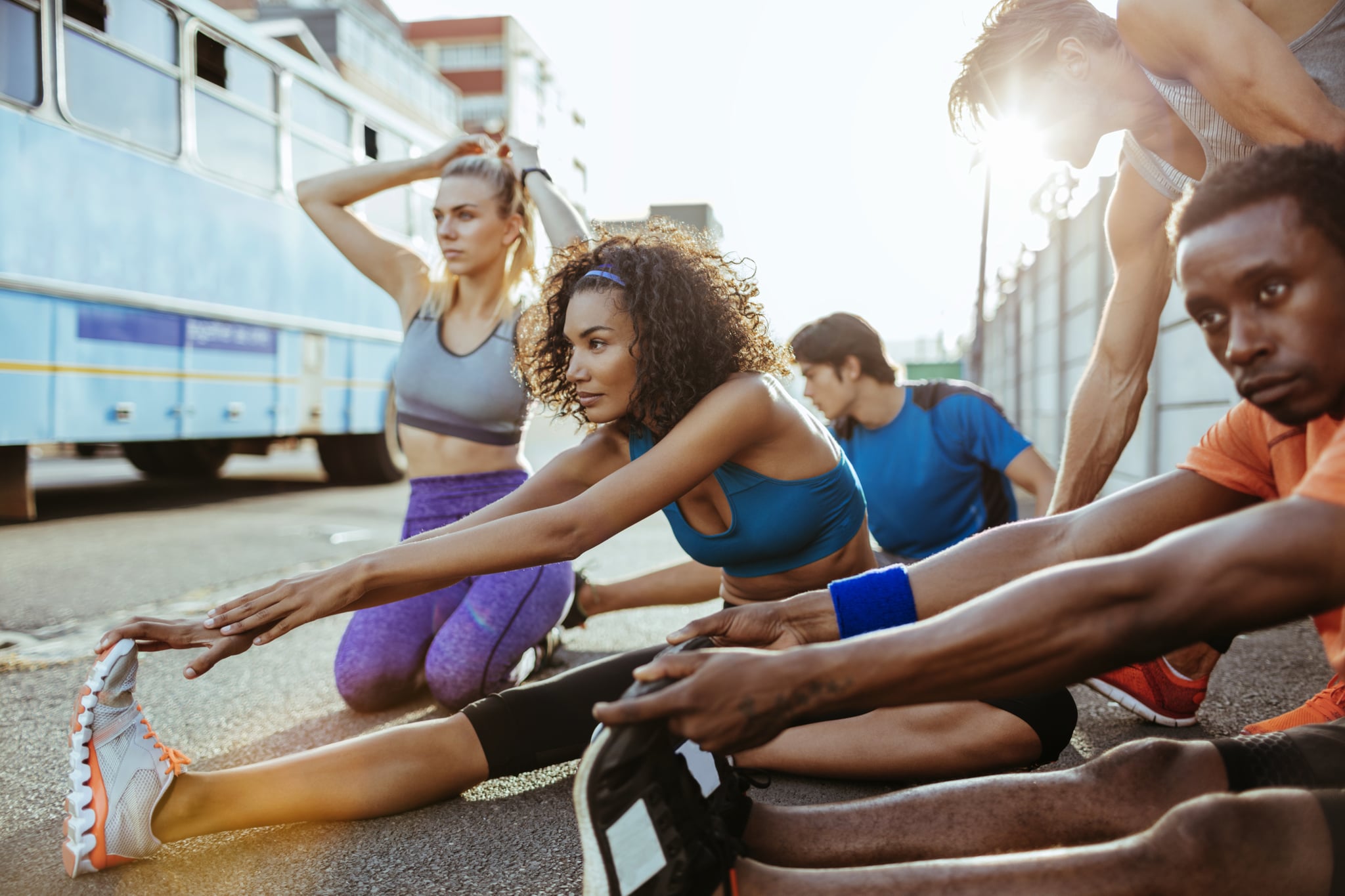 Close up of friends stretching