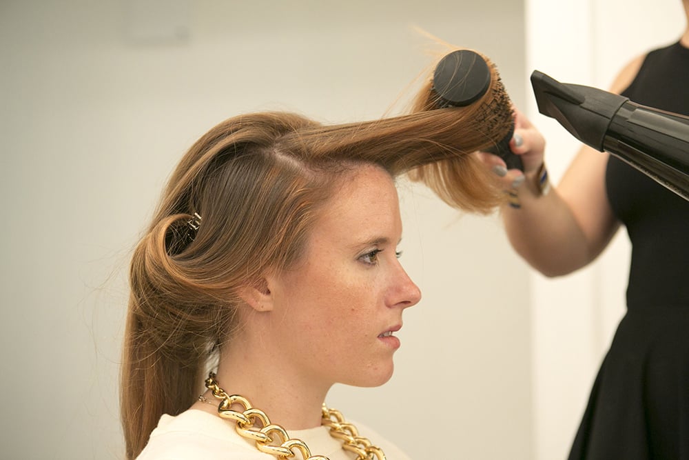 When you're blow-drying the top section that frames your face, you'll want to keep the section of hair curled away from your face. Don't forget to smooth the strands along your hairline before moving to the ends. 
Source: Caroline Voagen Nelson