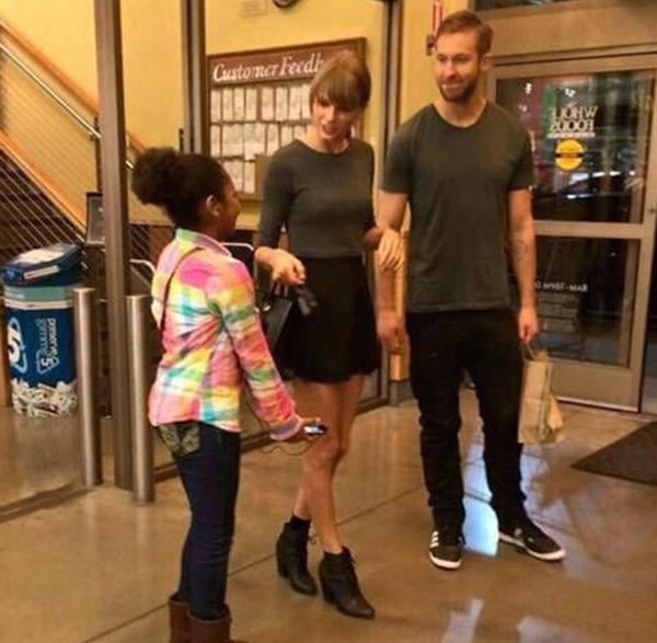 Taylor Swift and Calvin Harris were seen sporting coordinating outfits while chatting with a young fan.