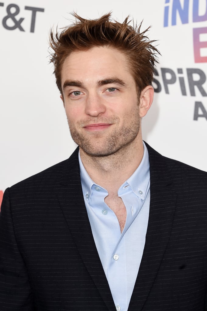 Robert Pattinson was hot like fire at the 2018 Independent Spirit Awards. The former Twilight star looked dapper in an all-black suit paired with a baby blue shirt which was unbuttoned at the top, revealing just a hint of chest hair. His sexy look was almost as distracting as his chiseled jawline; we admittedly couldn't stop staring as he walked the red carpet. Keep reading to see more photos of Robert, then check out his hottest photos over the years.