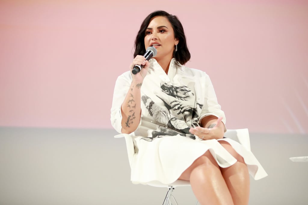 Demi Lovato has come a long way since she was hospitalized for an apparent drug overdose in July 2018, and she's reflecting on it all. Over the weekend, the 27-year-old singer appeared at the Teen Vogue Summit for her first public appearance since the scary incident last year, and she spoke candidly about the immense growth she's experienced. "What a lot of people don't realize is that I'm actually an extremely sensitive person," she said, according to The Hollywood Reporter. "I am human, so be easy on me. And I'm so tired of pretending like I'm not human. That's the one thing that I won't do anymore. When you say stuff, it affects me. I'm human."
And after everything she's been through over the last year, Demi is absolutely pleased with the person she is today, saying she's "never been more in tune" with herself. "[When I look in the mirror] I see someone that's overcome a lot. I genuinely see a fighter. I don't see a championship winner in there, but I see a fighter and I see someone that's going to continue to fight no matter [what] challenges are thrown their way."
"I see a fighter and I see someone that's going to continue to fight."
Demi has been open about her struggles with body acceptance throughout the years, but in her conversation with Teen Vogue's Lindsay Peoples Wagner, she admitted that's been one of her biggest accomplishments recently. She noted that in the past, she would lie to herself when she looked in the mirror and say she "loved" her body, but now she has genuinely come to "be OK" with what she sees. 
"I don't have to lie to myself and tell myself that I have this amazing body. It's like, if I don't feel it, I don't have to say that. All I have to say is I'm healthy. In that statement, I express gratitude and I express I am grateful for my strength." No matter what challenges have been thrown her way, Demi said confidently that she has no regrets. "I wouldn't change the direction of my life for anything . . . I would never regret anything. I love the person that I am today." 

    Related:

            
            
                                    
                            

            Demi Lovato Teases Her New Album, Says She Has "F*cking Fire Coming Soon"