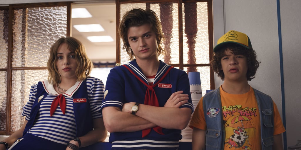 So when Stranger Things dropped an '80s-tastic teaser for the new season way back in July 2018, it left many fans scratching their heads. The 90-second teaser doesn't bother answering any lingering questions from season two; instead, it introduces a new shopping mall for the town of Hawkins, which is where Steve now works at a nautical-themed ice cream shop. (We much prefer him in babysitter mode, but looks like his friendship with Dustin is still going strong!)
Both the teaser and this photo show a glimpse of actress Maya Hawke, who plays a mysterious new character named Robin who happens to work with Steve. Netflix's previously released description of the character mentioned that "she seeks excitement in her life and gets more than she bargained for when she uncovers a dark secret in Hawkins, IN," so we can only imagine what the two of them will get up to.