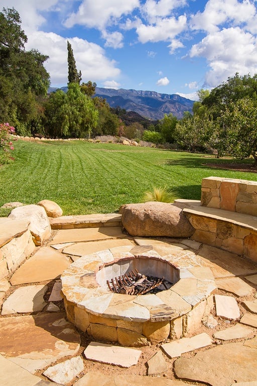 An outdoor fire pit is perfect for entertaining. We wonder if Emily and John make s'mores.