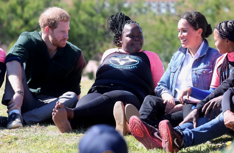 CAPE TOWN, SOUTH AFRICA - SEPTEMBER 24: Prince Harry, Duke of Sussex and Meghan, Duchess of Sussex join surf mentors and participate in a group activity to promote positive thinking, as they visit Waves for Change, an NGO, at Monwabisi Beach on September 
