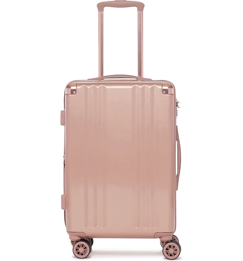 一个粉红色行李箱:Calpak Ambeur 22英寸滚动转子随身携带