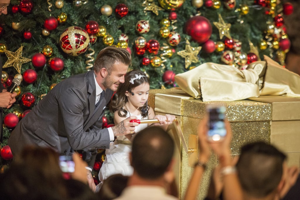 David Beckham helped a young lady open a giant gift box at the Festive Light Up event in Singapore on Saturday.
