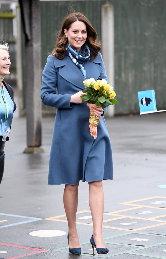 During a visit to the Roe Green Junior School, Kate wore a blue Sportmax coat which she accessorised with a printed Beulah London scarf.