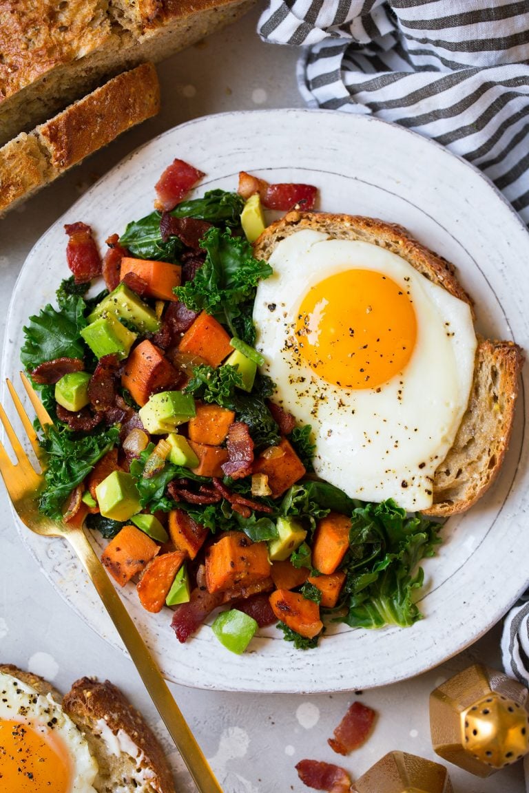 Sweet Potato, Kale, Bacon, and Avocado Hash With Fried Eggs