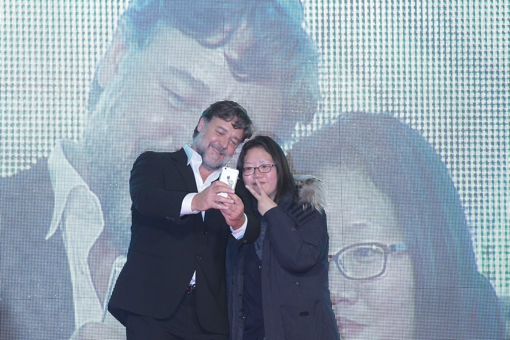 Russell Crowe snapped a selfie with a fan at the Monday premiere of The Water Diviner in Seoul, South Korea.