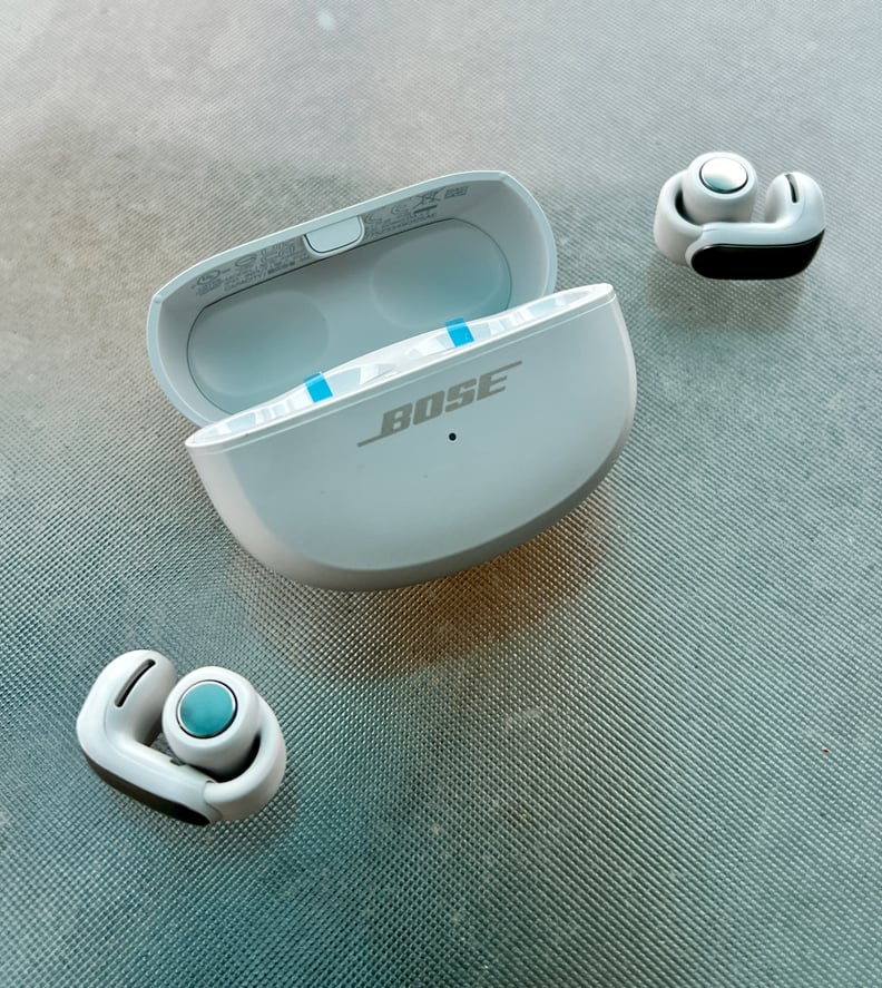 Bose Ultra Open Earbuds sitting on a table