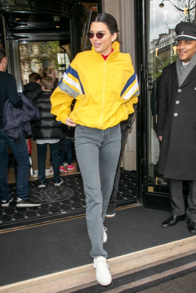 In April, Kendall was spotted in Paris wearing a sunshine-yellow jacket from Balenciaga's Spring 2018 menswear line. She paired it with grey Yeezy mom jeans, white Adidas sneakers, and sunglasses.