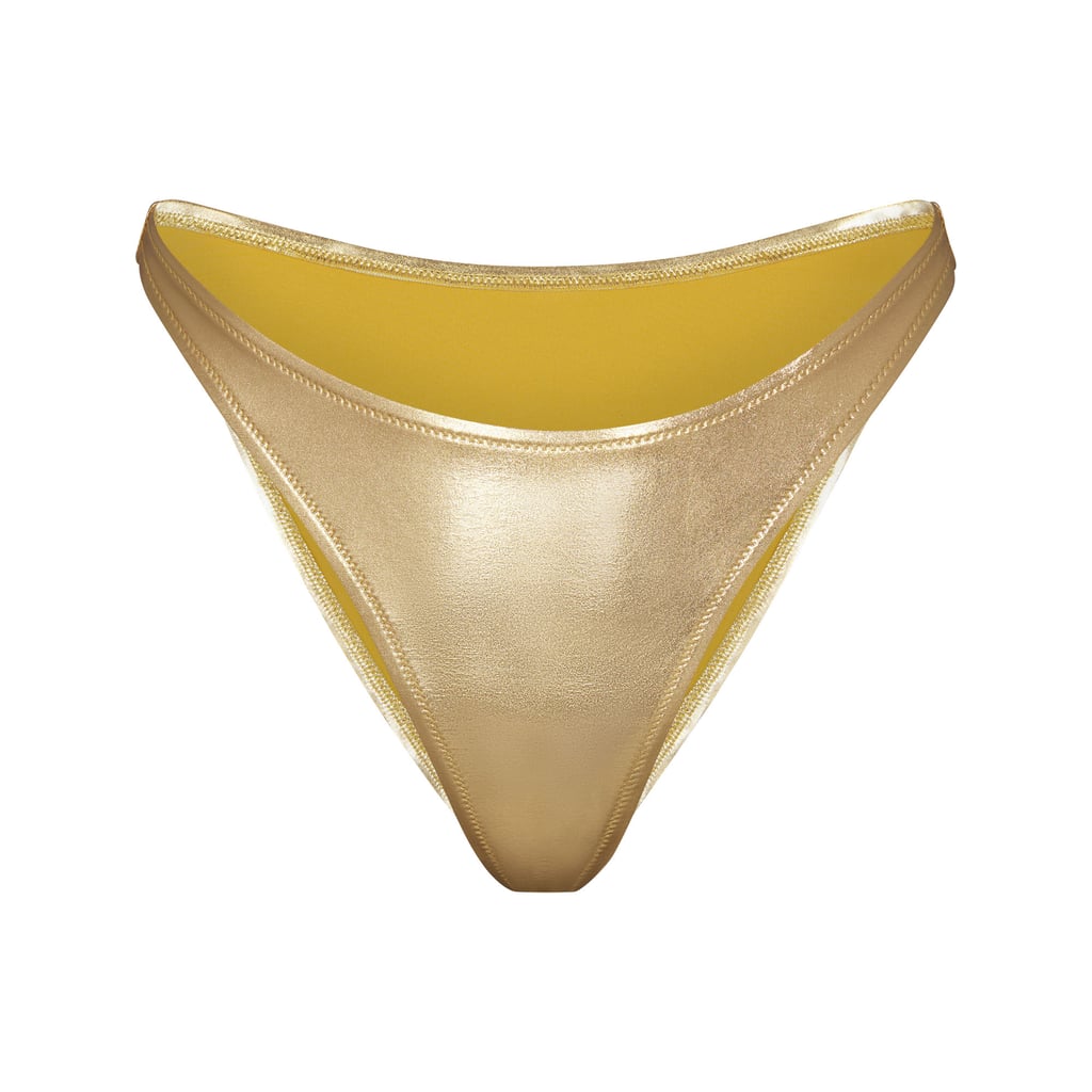 Skims Metallic Swim Dipped Mid-Waist Bottoms in Gold ($48)