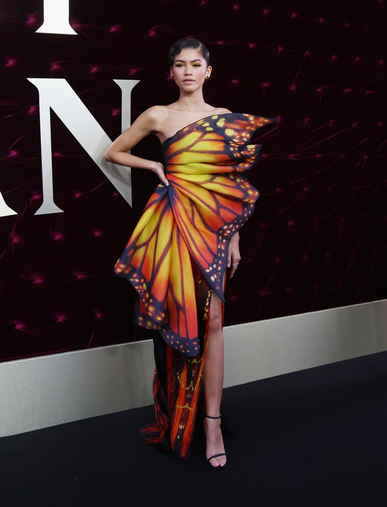 Zendaya's Moschino butterfly dress at the Australia premiere of The Greatest Showman called for little more than a pair of Stuart Weitzman sandals. She arrived to the carpet under an umbrella, sheltered from the rain and ready to spread her wings.