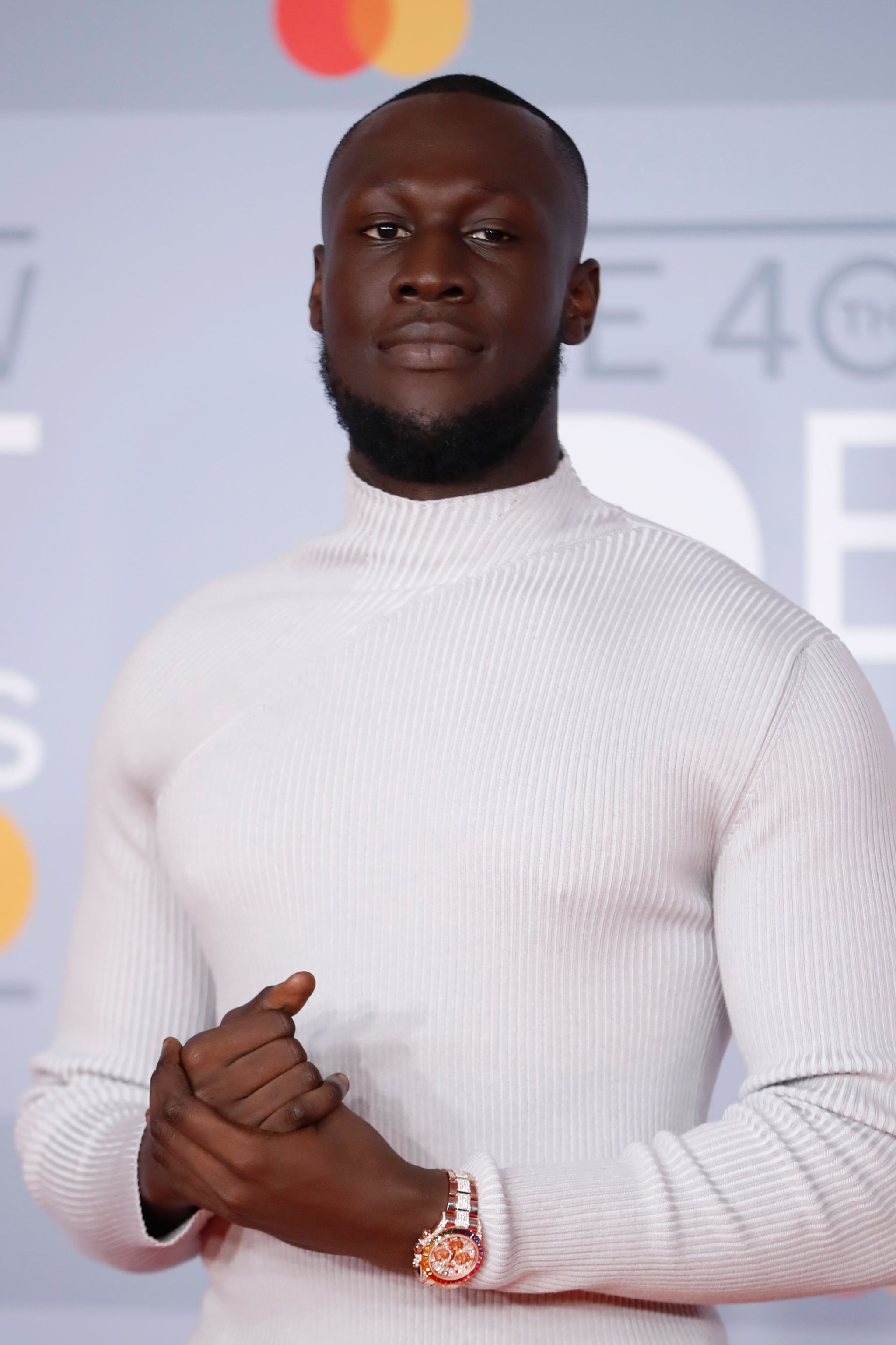 British grime and hip-hop artist Stormzy poses on the red carpet on arrival for the BRIT Awards 2020 in London on February 18, 2020. (Photo by Tolga AKMEN / AFP) / RESTRICTED TO EDITORIAL USE  NO POSTERS  NO MERCHANDISE NO USE IN PUBLICATIONS DEVOTED TO ARTISTS (Photo by TOLGA AKMEN/AFP via Getty Images)