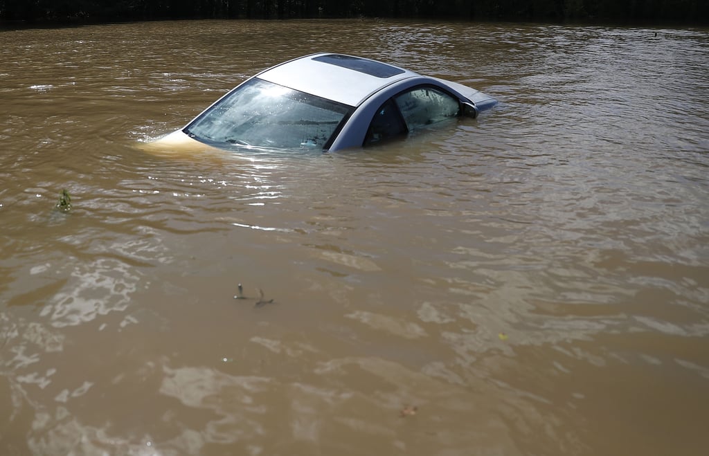A car is nearly fully submerged by the water in Port Vincent, LA. Pictures of Louisiana