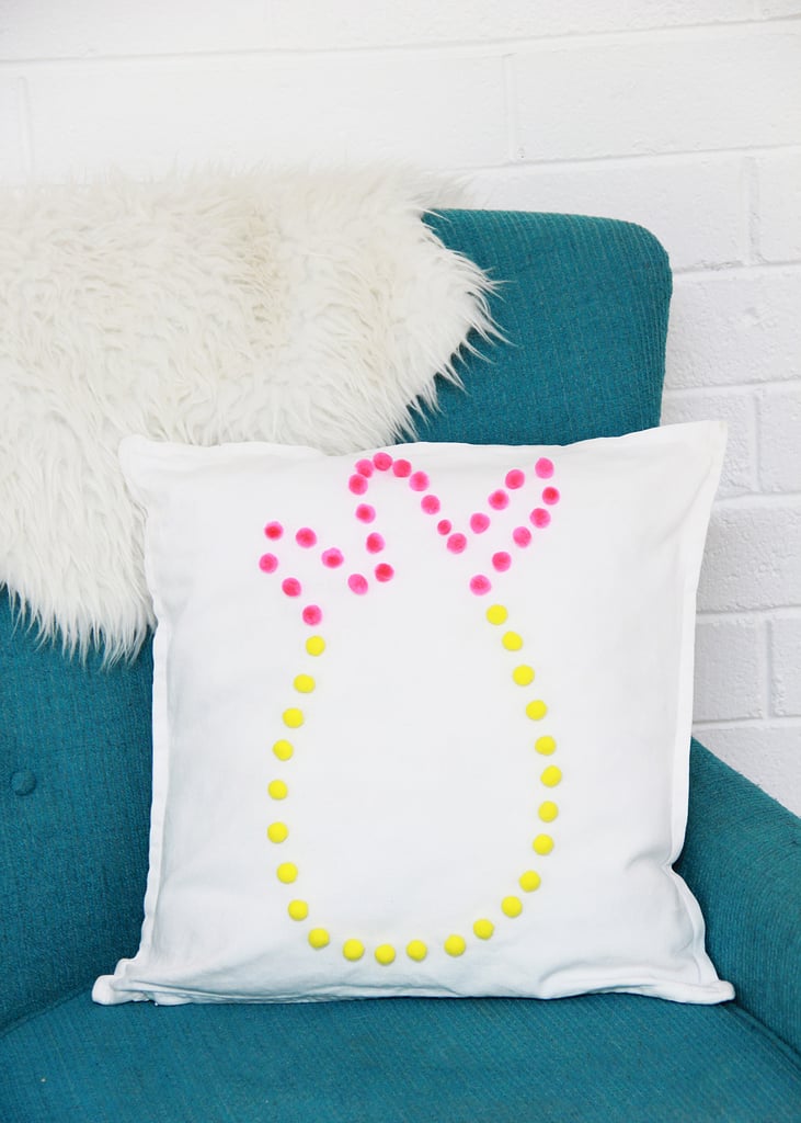 Remove the cardboard, add a pillow to the case, and enjoy! A pineapple pom-pom pillow will make your house feel like Summer all year long.