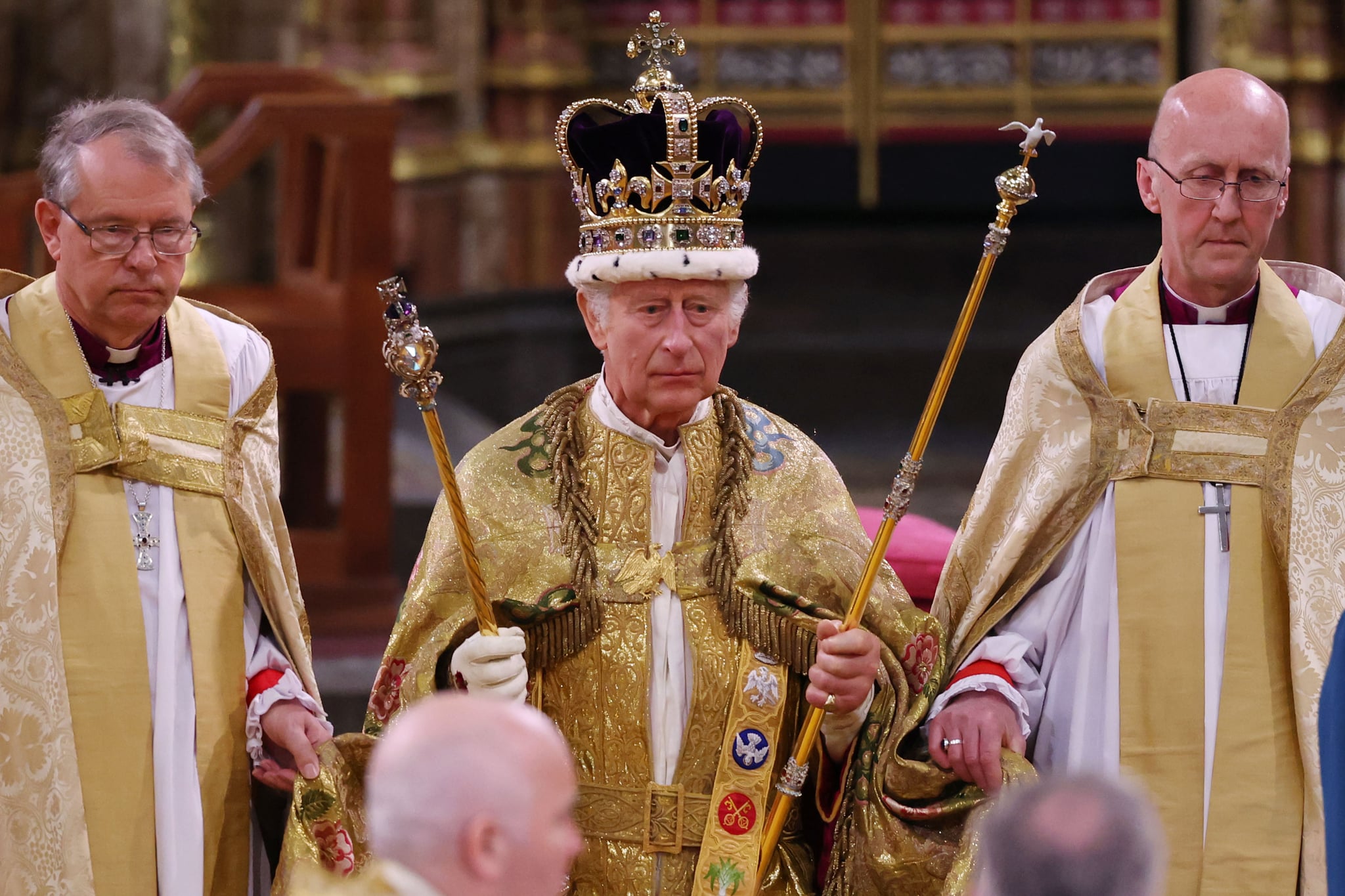 LONDON, ENGLAND - MAY 06:  King Charles III stands after being crowned during his coronation ceremony in Westminster Abbey, on May 6, 2023 in London, England. The Coronation of Charles III and his wife, Camilla, as King and Queen of the United Kingdom of Great Britain and Northern Ireland, and the other Commonwealth realms takes place at Westminster Abbey today. Charles acceded to the throne on 8 September 2022, upon the death of his mother, Elizabeth II. (Photo by Richard Pohle - WPA Pool/Getty Images)