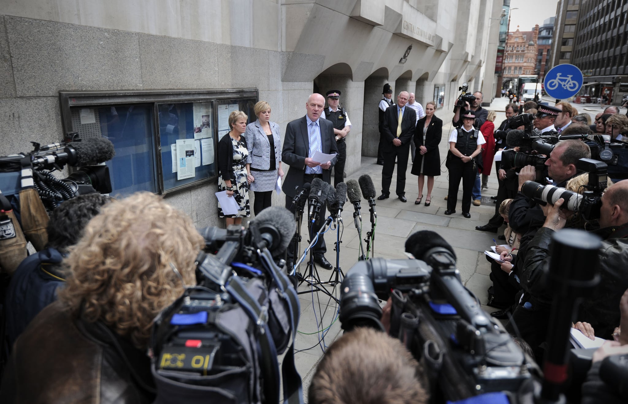 The mother and sister of murdered schoolgirl Amanda Dowler, Sally (L) and Gemma (2nd L), listen as father Bob Dowler (3rd L) reads a statement outside the Old Bailey in central London, on June 24, 2011. Surrey Police apologised today for mistakes in the Milly Dowler investigation. Convicted killer Levi Bellfield was given a second whole-life jail term today for the murder of schoolgirl Milly Dowler. Relatives of the 13-year-old, snatched from the street on her way home in March 2002, hugged each other as Bellfield was told he would never be released. He is already serving a whole-life term for the murders of French student Amelie Delagrange and Marsha McDonnell and the attempted murder of Kate Sheedy.  AFP PHOTO / CARL COURT (Photo credit should read CARL COURT/AFP/Getty Images)