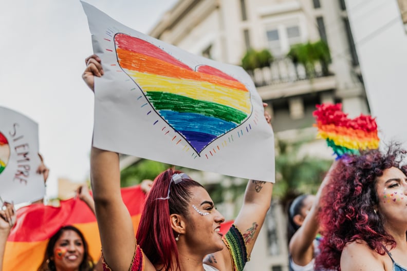 LGBTQIA+ people marching during social movement protesting outdoors