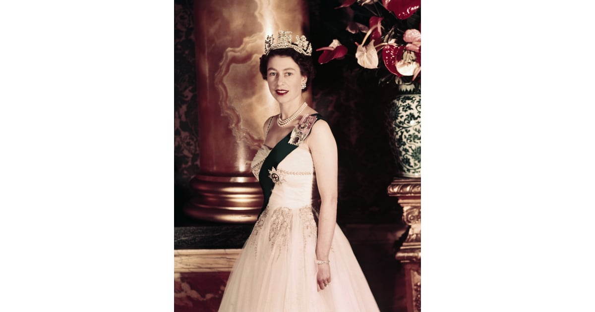 Queen Elizabeth II poses wearing a formal sash and crown in 1955