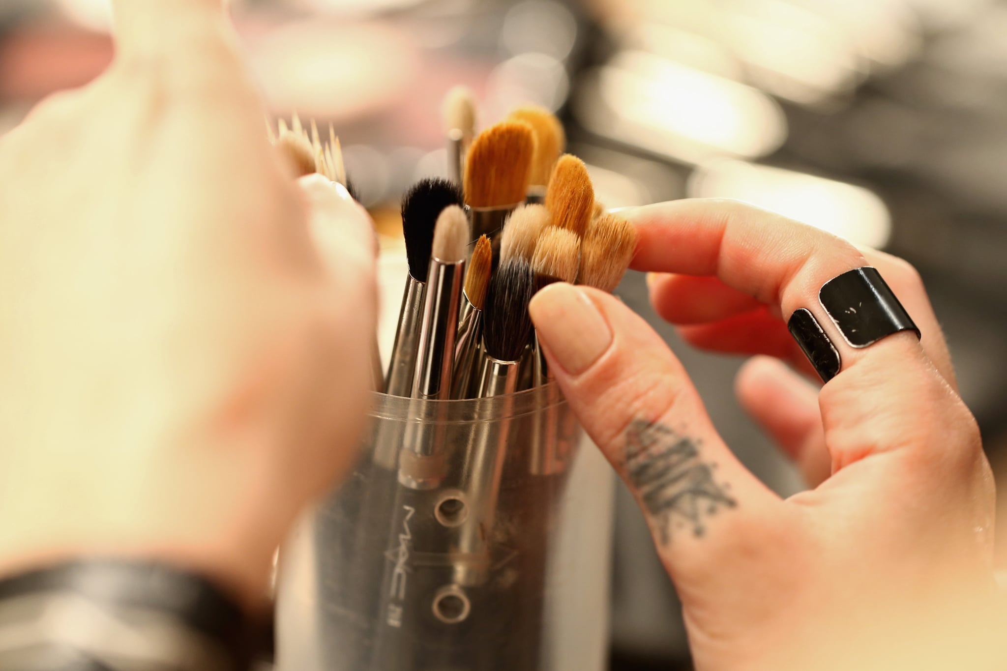 ISTANBUL, TURKEY - MARCH 15:  A make-up artist reaches for a brush during the Mercedes-Benz Fashion Week Istanbul Autumn/Winter 2016 at Zorlu Center on March 15, 2016 in Istanbul, Turkey.  (Photo by Andreas Rentz/Getty Images for IMG)