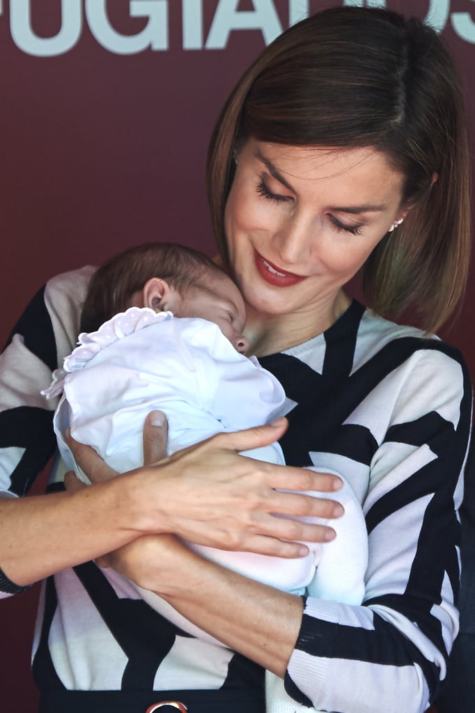 Queen Letizia Holds a Baby in Madrid Pictures