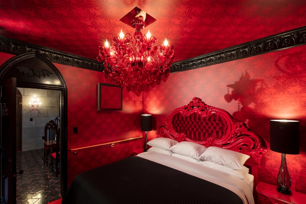 Take a Peek at the Blood-Red Downstairs Bedroom With, Yep, an Elegant Chandelier
