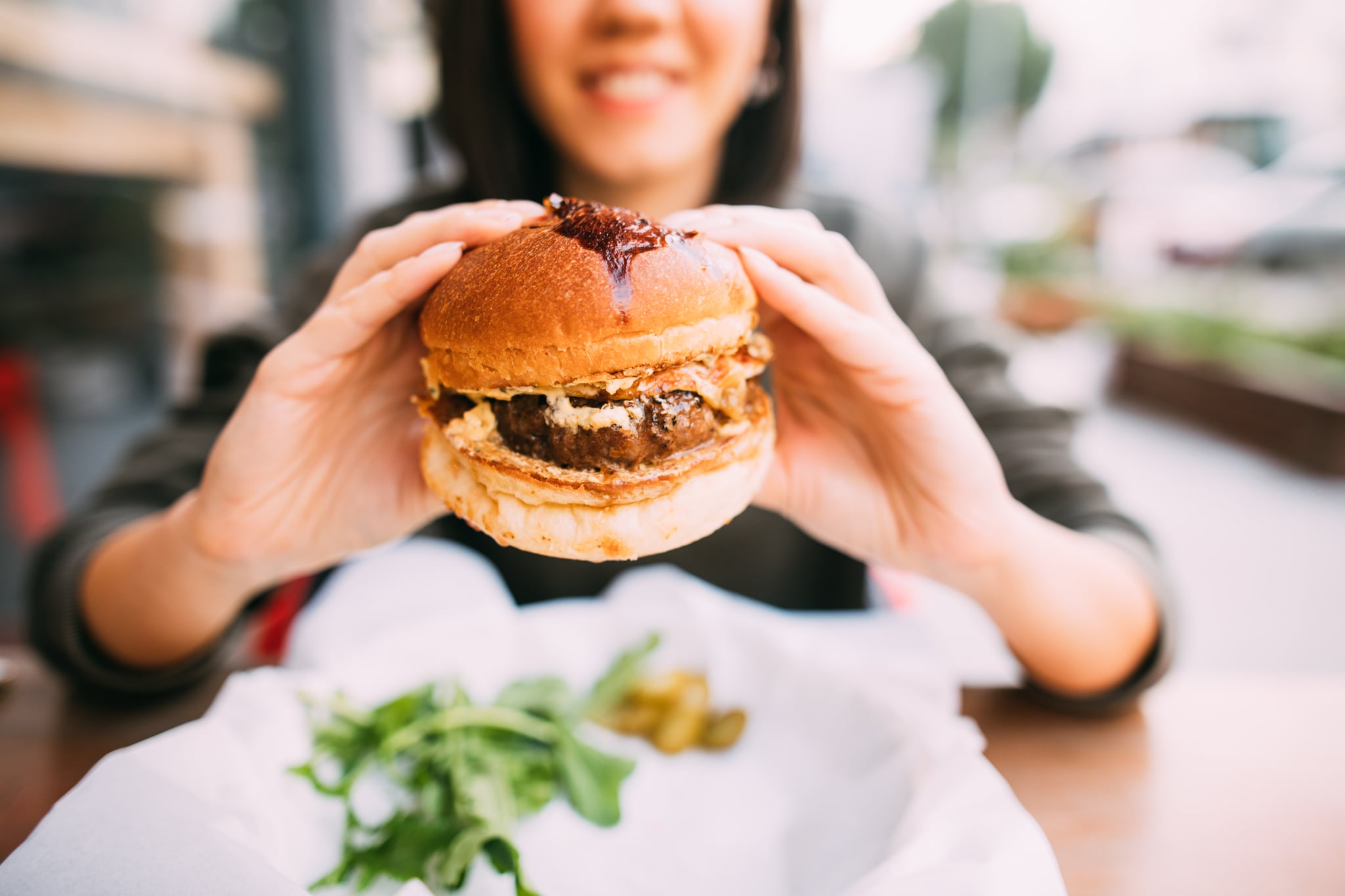 Woman eating beef burger