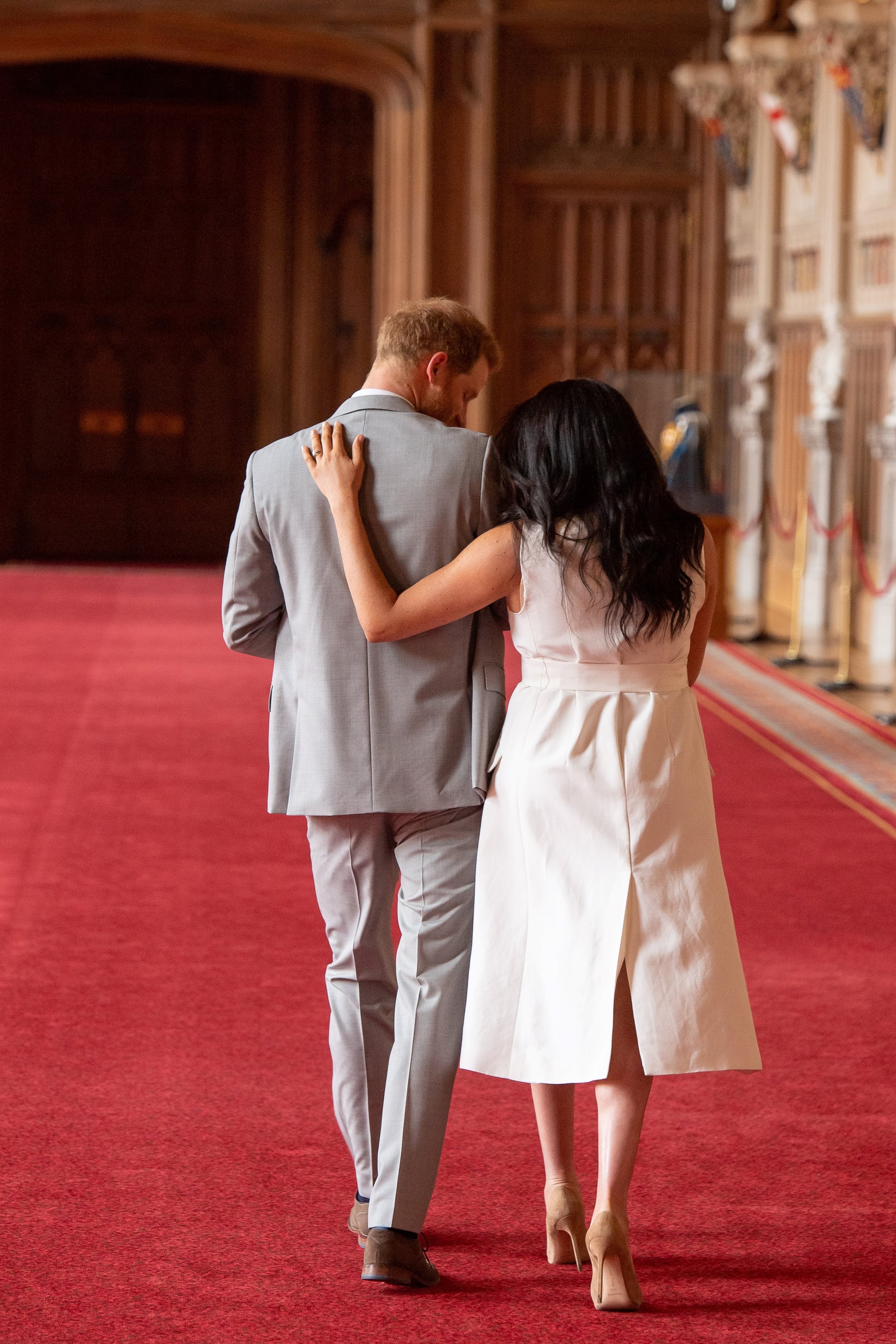 TOPSHOT - Britain's Prince Harry, Duke of Sussex (L), and his wife Meghan, Duchess of Sussex, walk away after posing for photographs with their newborn baby son, Archie Harrison Mountbatten-Windsor, in St George's Hall at Windsor Castle in Windsor, west of London on May 8, 2019. (Photo by Dominic Lipinski / POOL / AFP) (Photo by DOMINIC LIPINSKI/POOL/AFP via Getty Images)