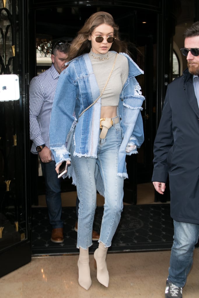 This denim on denim look is infinitely more interesting thanks to Gigi's crop top, two-tone jeans, and distressed jacket.  
