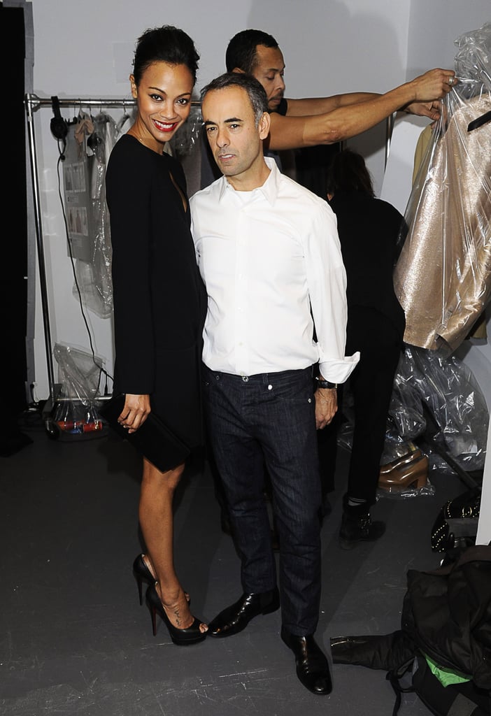 Zoe hung out backstage with Francisco Costa during the Fall 2011 Calvin Klein show, wearing a black sheath dress from the collection.