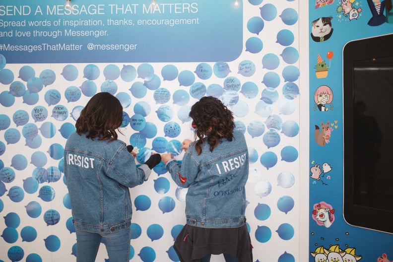 Two women added messages to the wall.