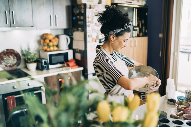 Close-up of a beautiful woman baking muffins