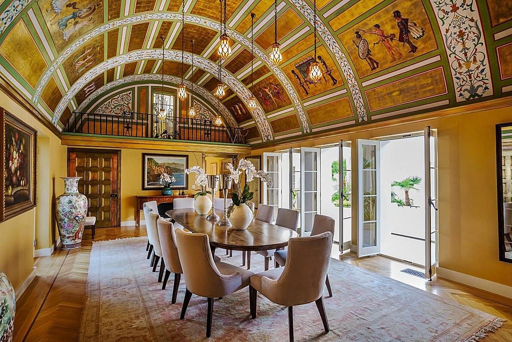 The hand-painted ceiling of this dining room is truly a masterpiece.