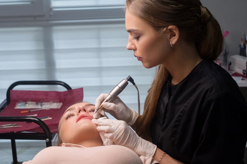 Permanent make up procedure. Lip makeup in tattoo salon