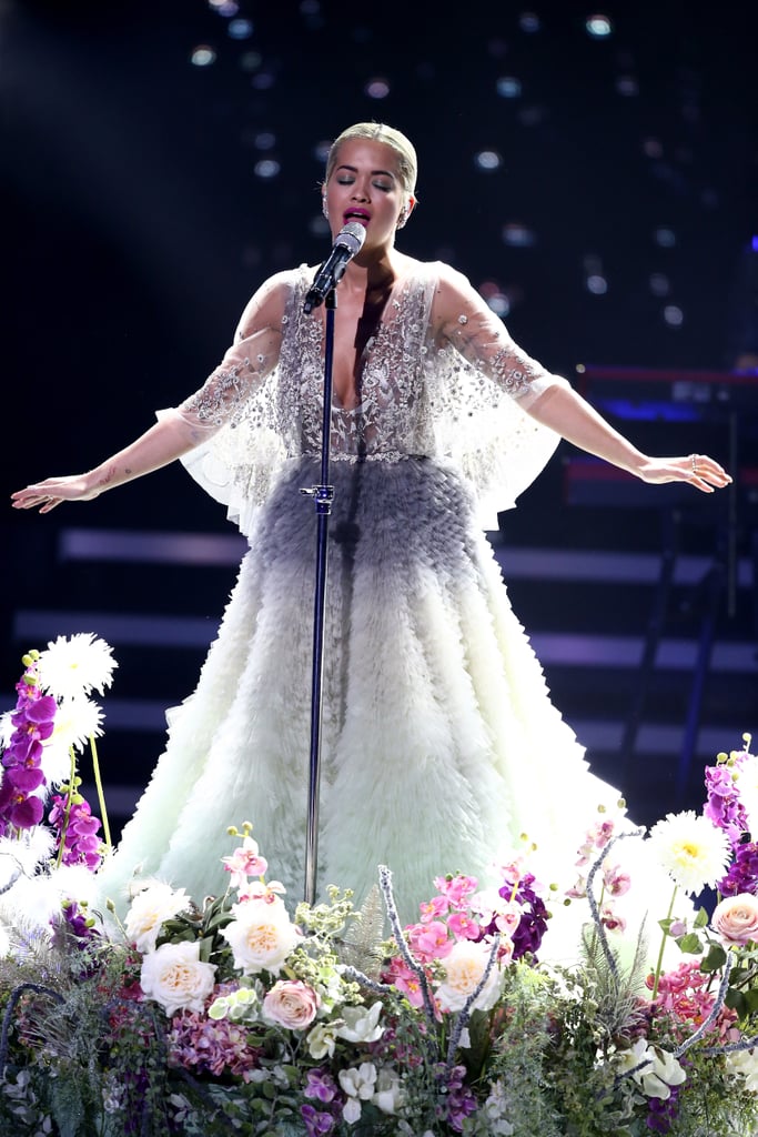 Rita performed on stage, showing off her cape sleeves that looked like wings.