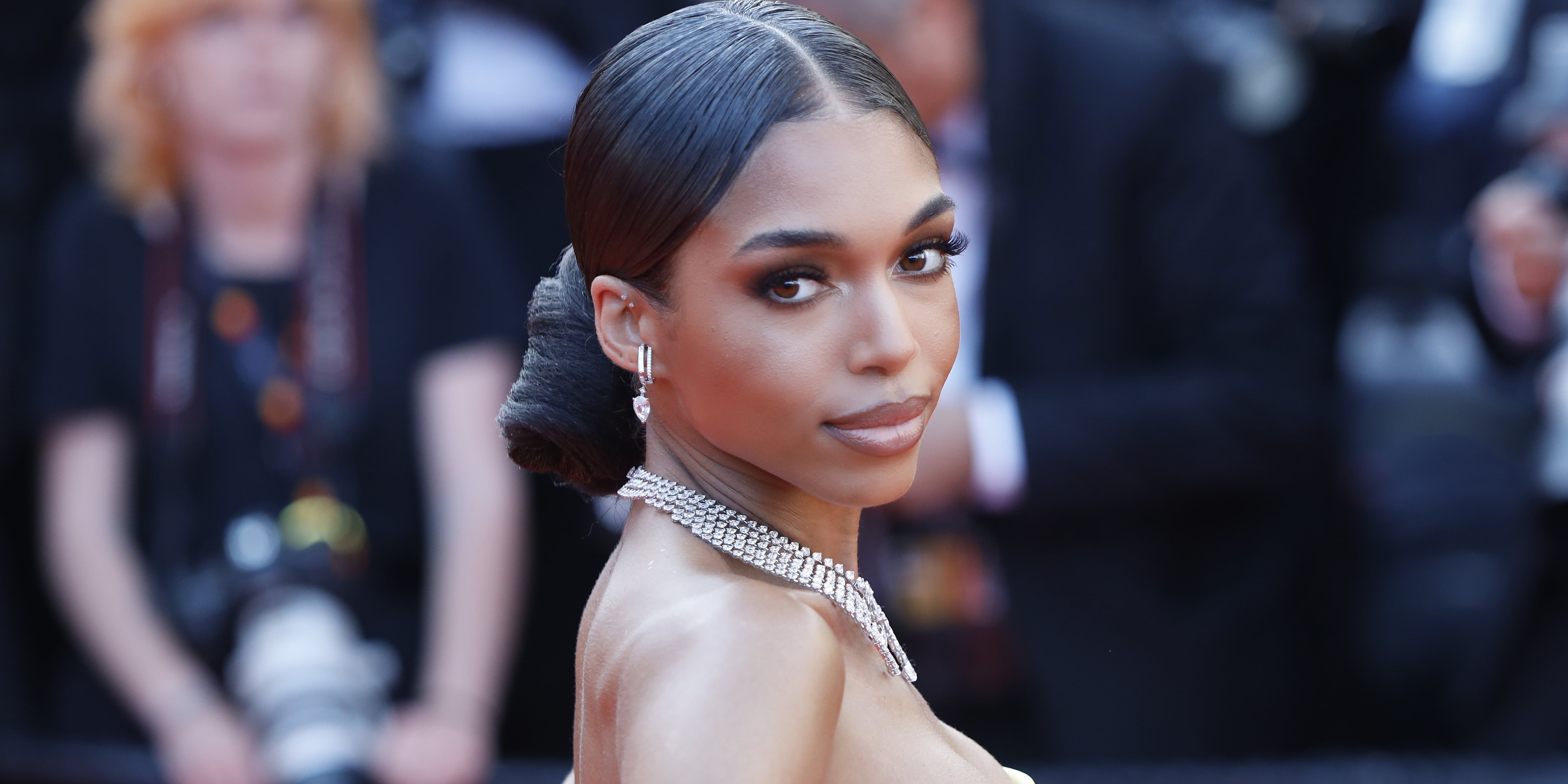 Lori Harvey Goes Sporty-Chic In Bra Top, Yankees Jacket & Sharp