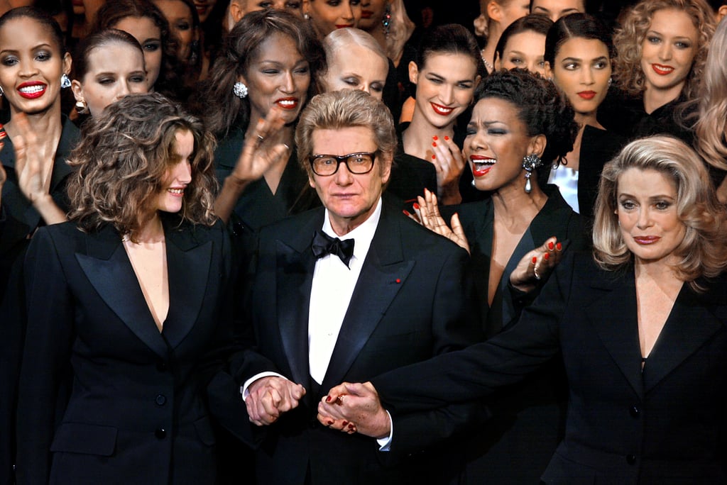 An epic moment for the designer, as he took a stroll to the end of the catwalk with his iconic muses Catherine Deneuve and Laetitia Casta at his final haute couture show (ever) in 2002.
An epic moment for the designer, as he took a stroll to the end of the catwalk with his iconic muses Catherine Deneuve and Laetitia Casta at his final haute couture show (ever) in 2002.