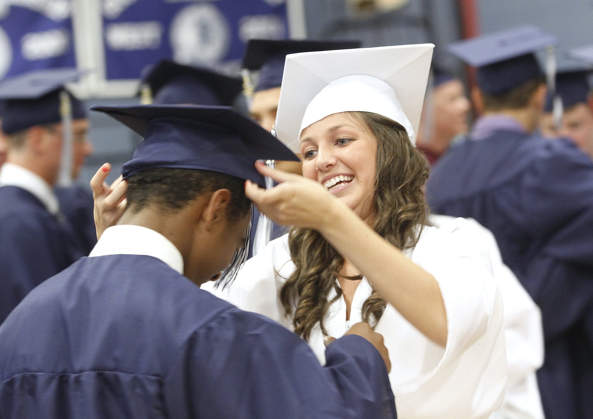 Westbrook High School Graduation. Kaelyn Galipeau helps classmate Jeremiah Steele with his cap before the start of graduation ceremonies. Photographed on Friday, June 8, 2012.  (Photo by Derek Davis/Portland Press Herald via Getty Images)