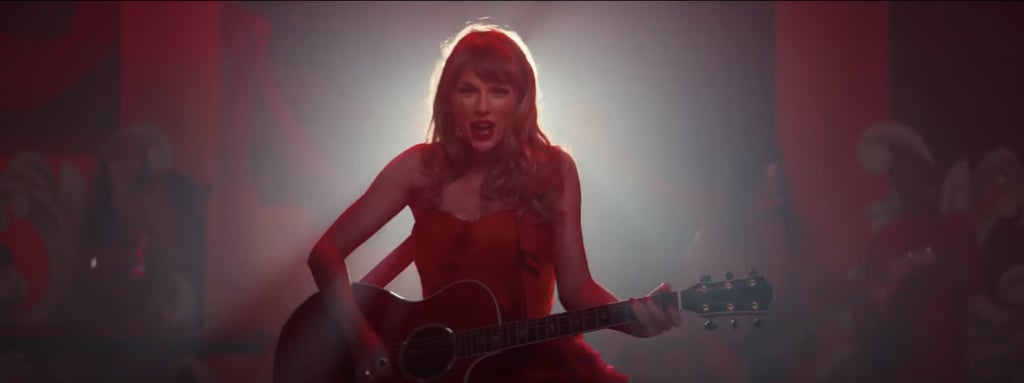 Taylor Swift's "reddest video ever" is here! The singer surprised fans on Sunday morning when she revealed she'd be dropping a music video for "I Bet You Think About Me (Taylor's Version)" the following day, and honestly? We couldn't have asked for a better drop and better outfits. 
Directed by Blake Lively – aka Betty's mom herself — the production centers around her ex (Miles Teller)'s wedding, where Taylor is seen dressed as different players at such event, including a server, various types of wedding guests, flower girl, performer, and even a bride. And of course, (almost) every single outfit, styled by Joseph Cassell Falconer, is the same bright shade of red. There's much to unpack about each ensemble, so take a closer look at every dress (plus one suit) ahead.

    Related:

            
            
                                    
                            

            Taylor Swift Just Wore Her Own Damn Version of Princess Diana’s Iconic "Revenge Dress"