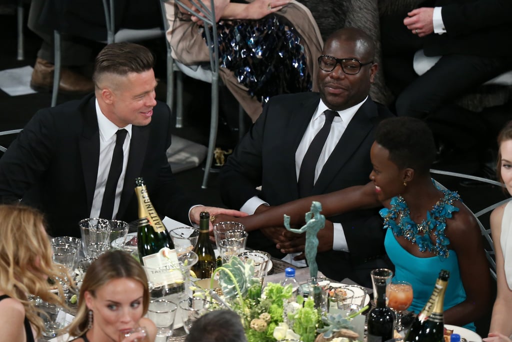 Brad Pitt chatted up Lupita Nyong'o and Steve McQueen at their table.