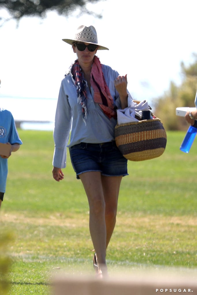 Julia wore bohemian separates, including a printed scarf, a fedora, a straw tote, and denim shorts, while out in Malibu in October 2016.